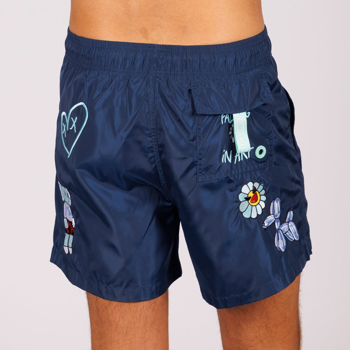 Navy blue swim shorts back view with illustrated graphic
