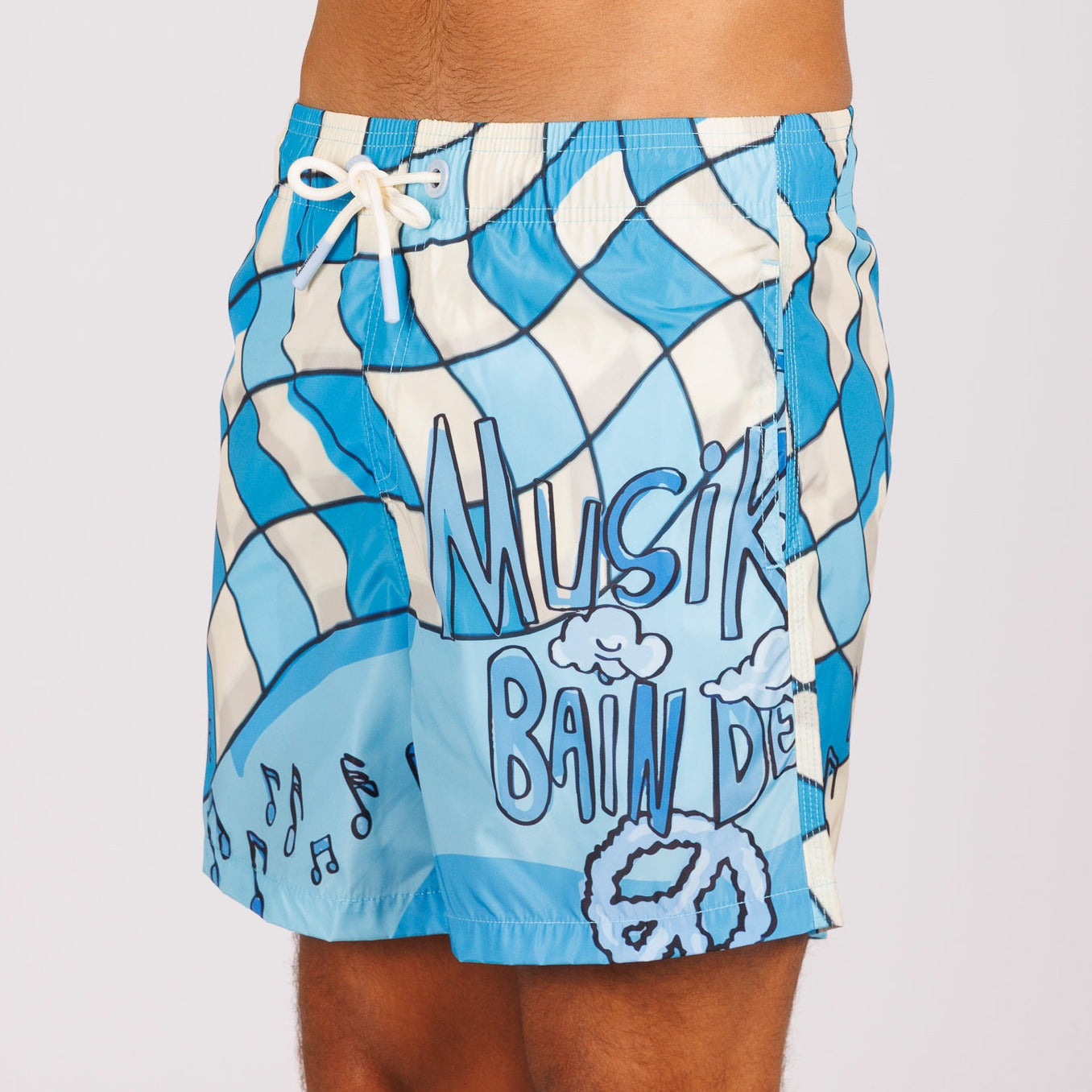 Blue swim shorts side view with all-over illustrated graphic and text