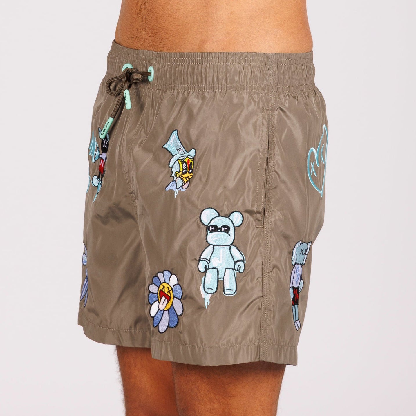 Khaki swim shorts side view with illustrated graphic