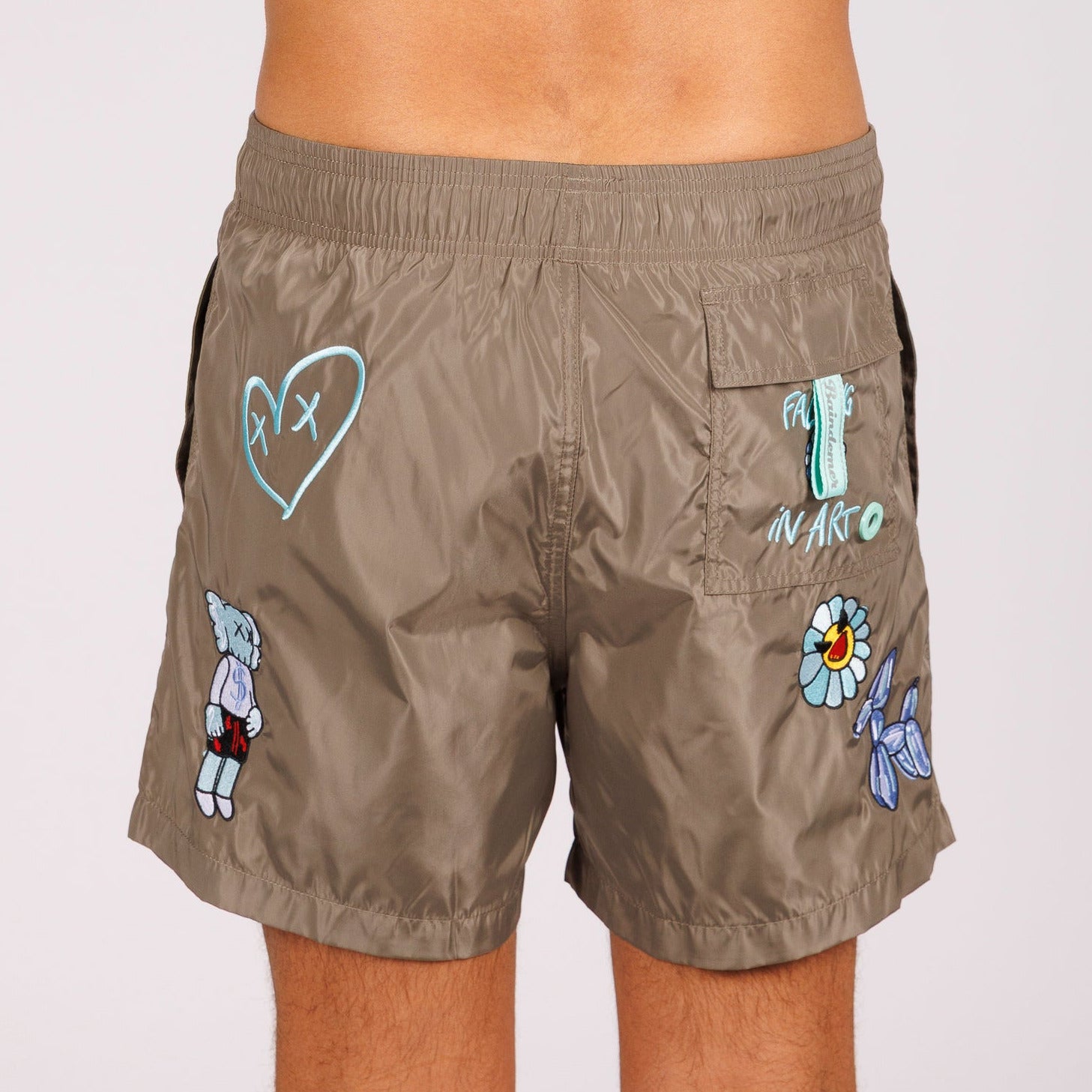 Khaki swim shorts back view with illustrated graphic
