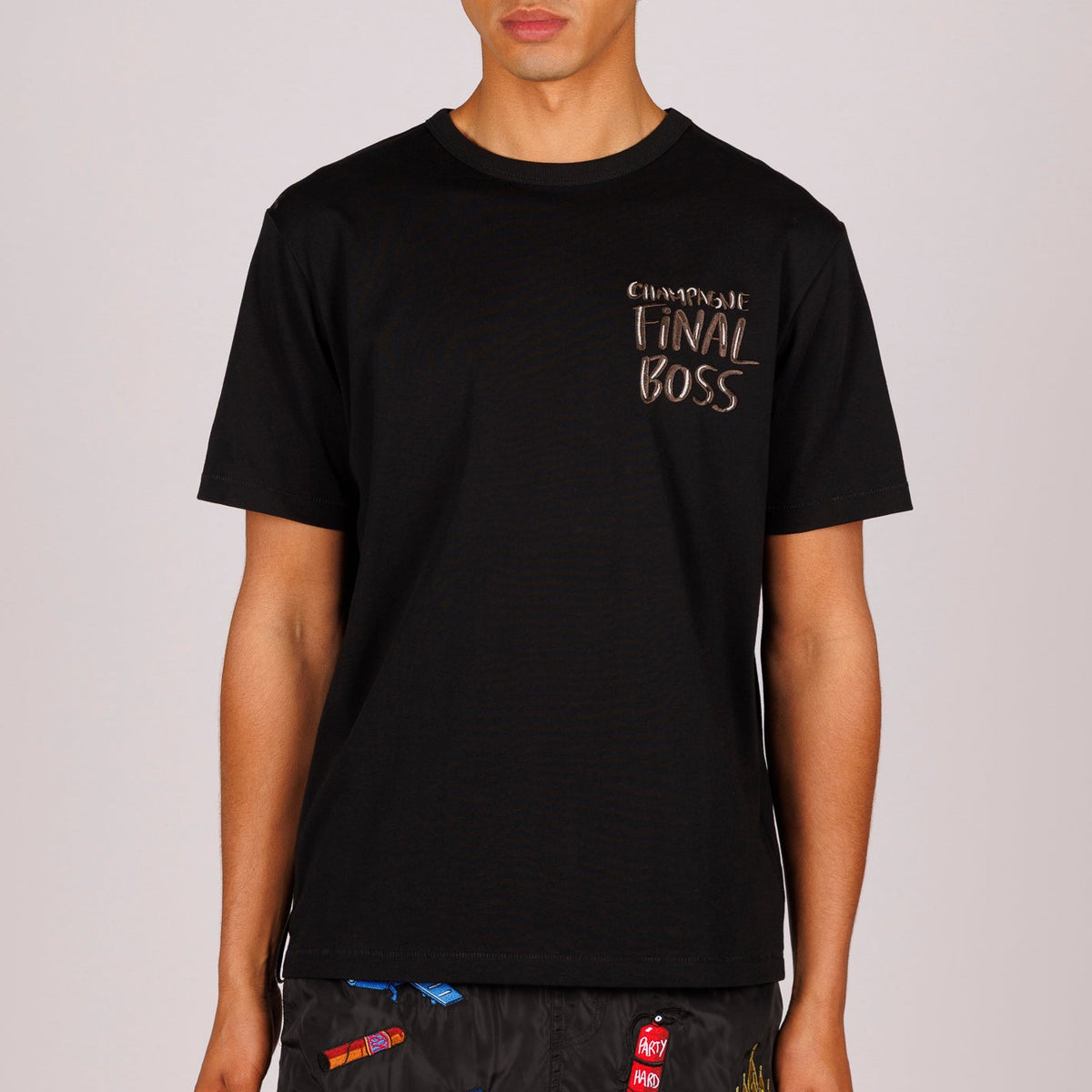 Black T-shirt front view with “Champagne final boss” text