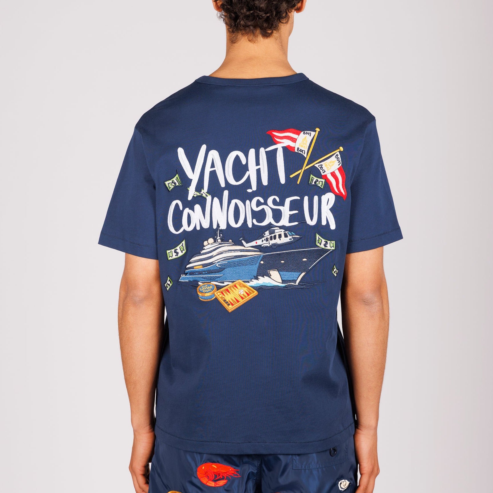 Navy blue T-shirt back view with illustrated graphic and “Yacht connoisseur” text