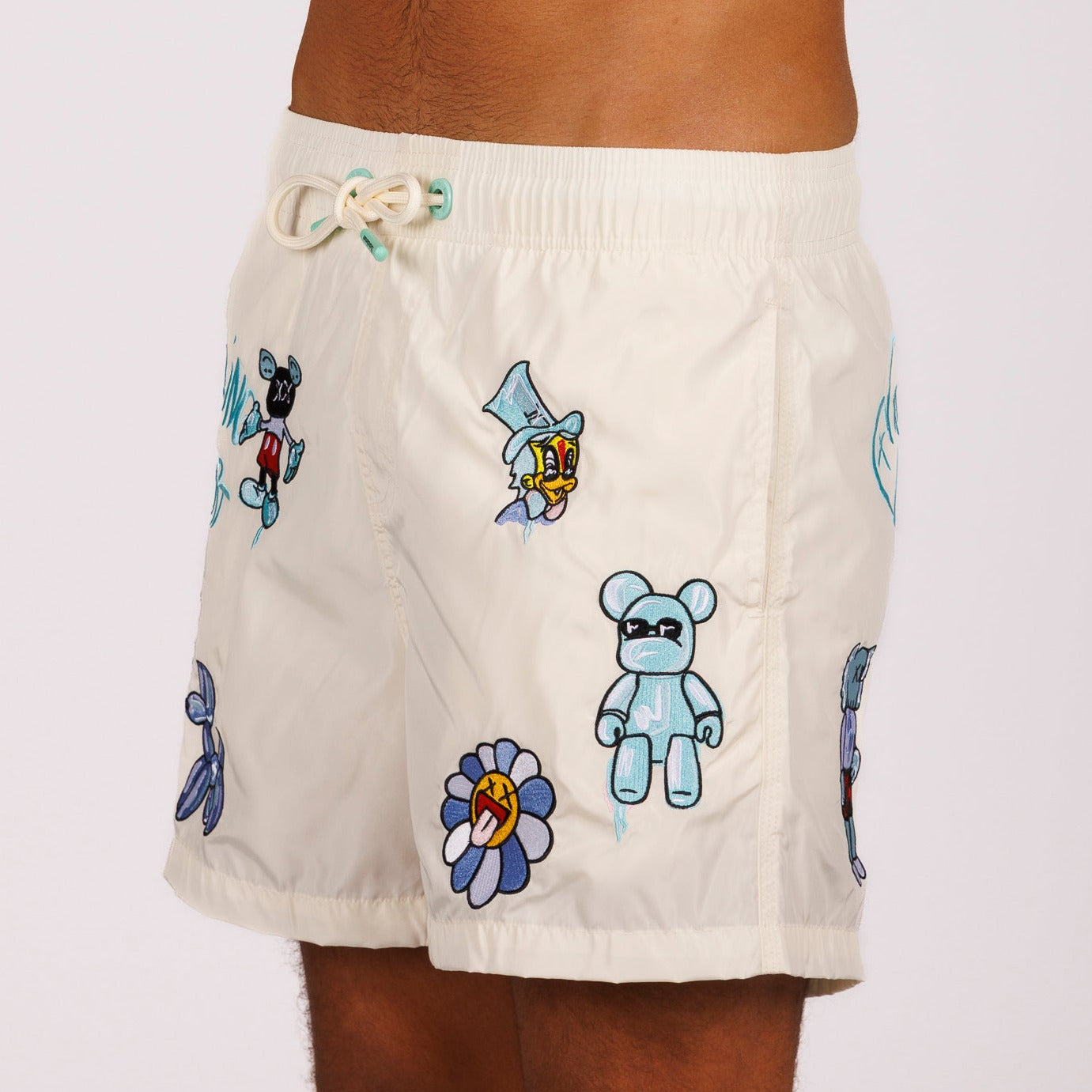 Off-white swim shorts side view with illustrated graphic