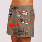 Khaki swim shorts side view with illustrated graphic and “Yacht connoisseur” text
