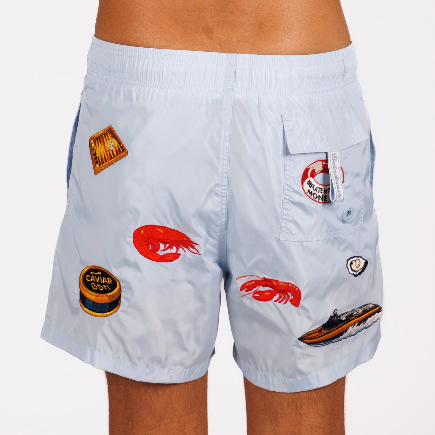 Light blue swim shorts back view with illustrated graphic