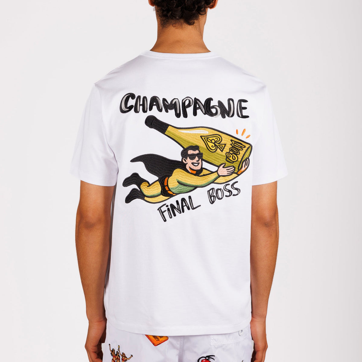 White T-shirt back view with illustrated graphic and “Champagne final boss” text