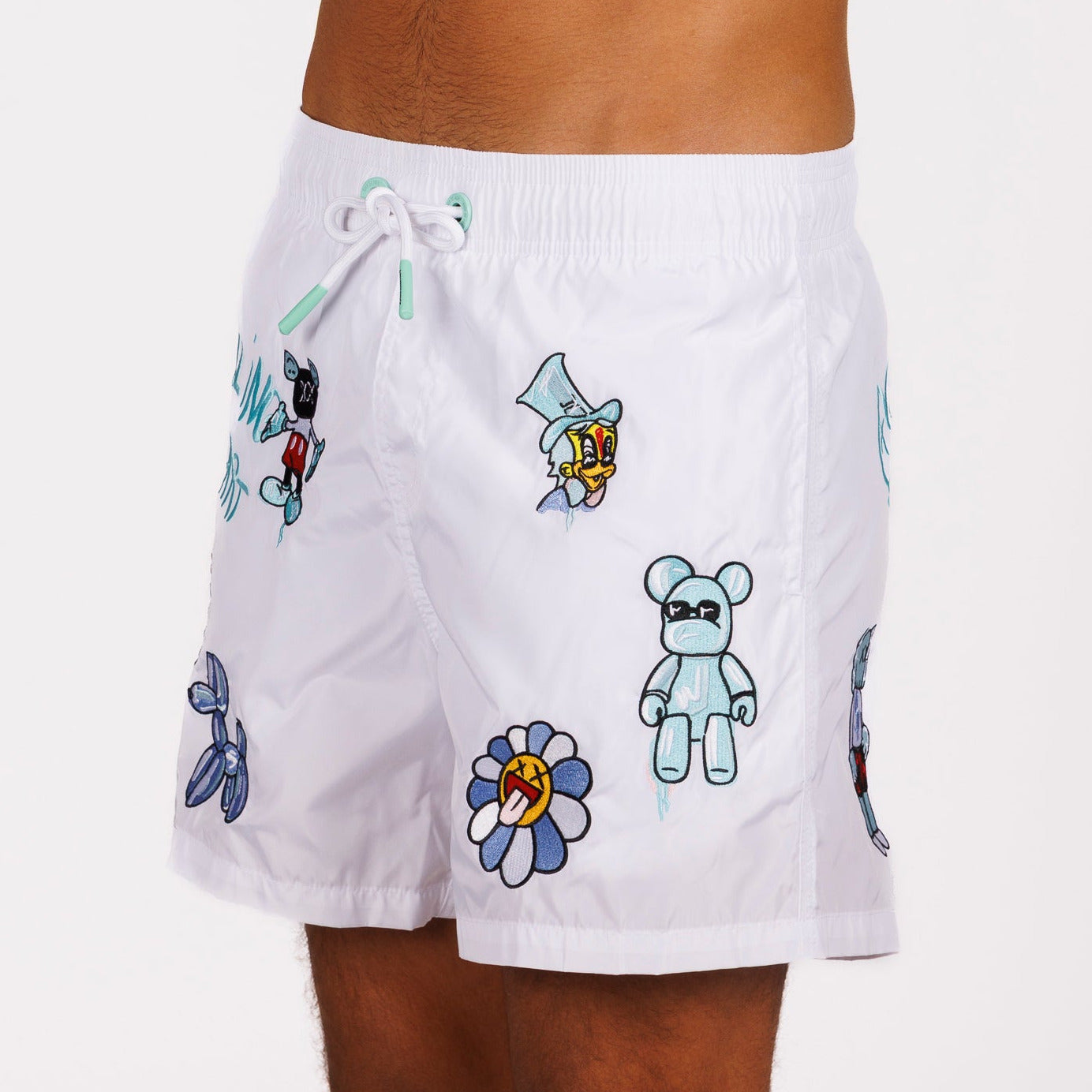 White swim shorts side view with illustrated graphic