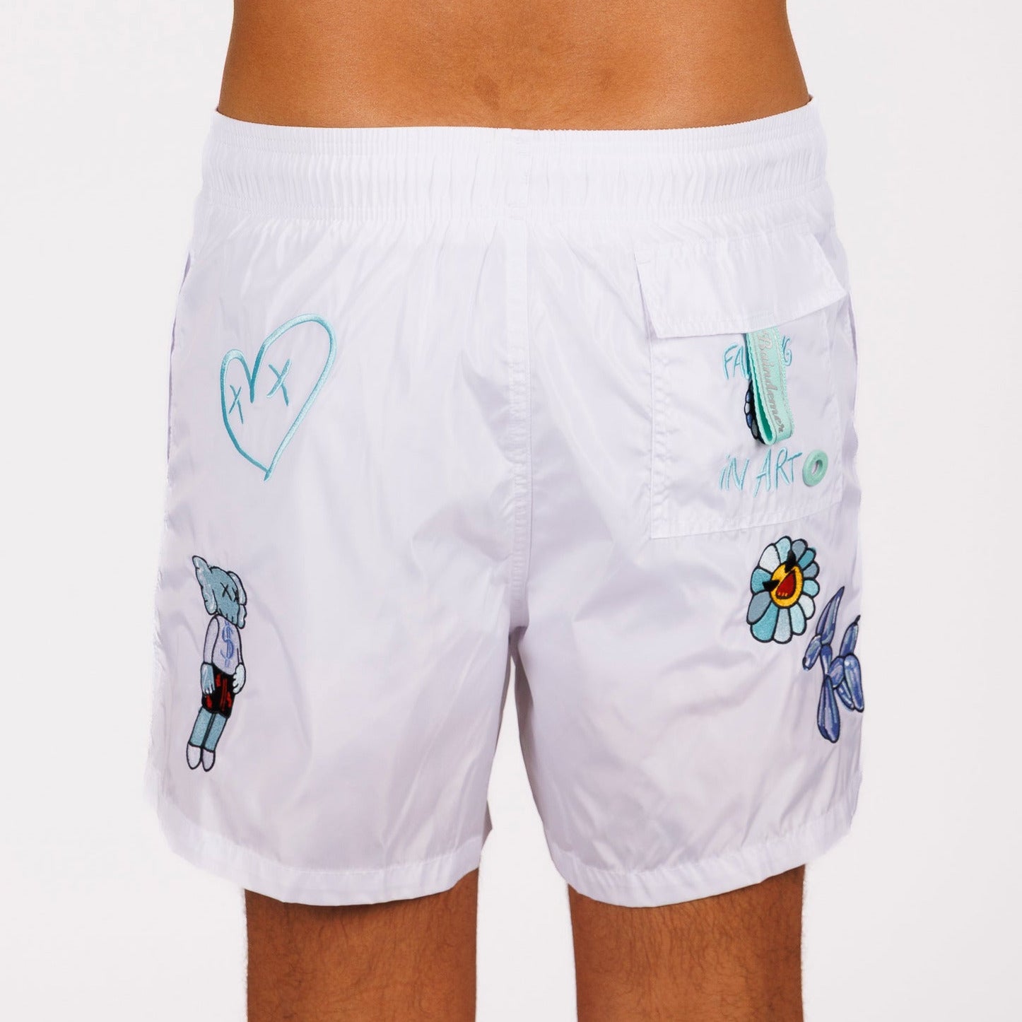 White swim shorts back view with illustrated graphic