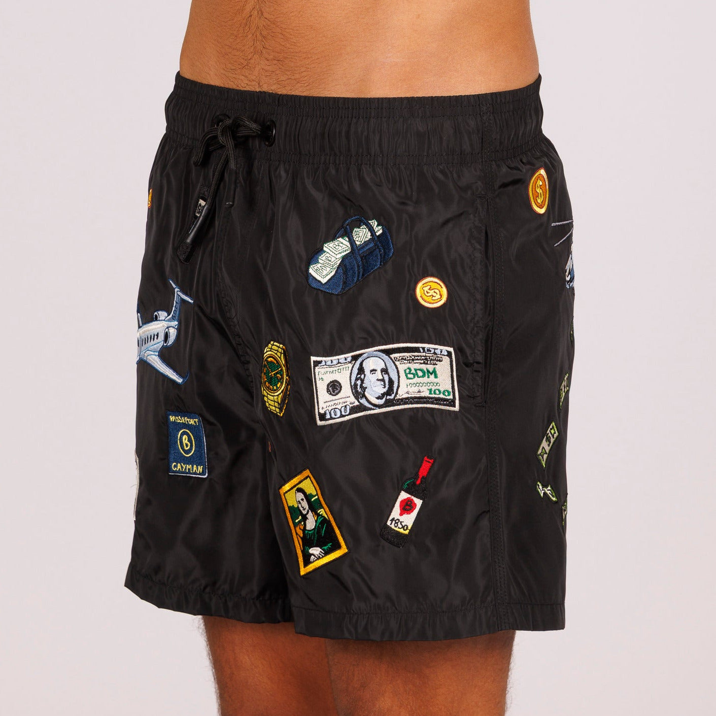 Black swim shorts side view with illustrated graphic