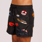Black swim shorts side view with illustrated graphic and “Yacht connoisseur” text