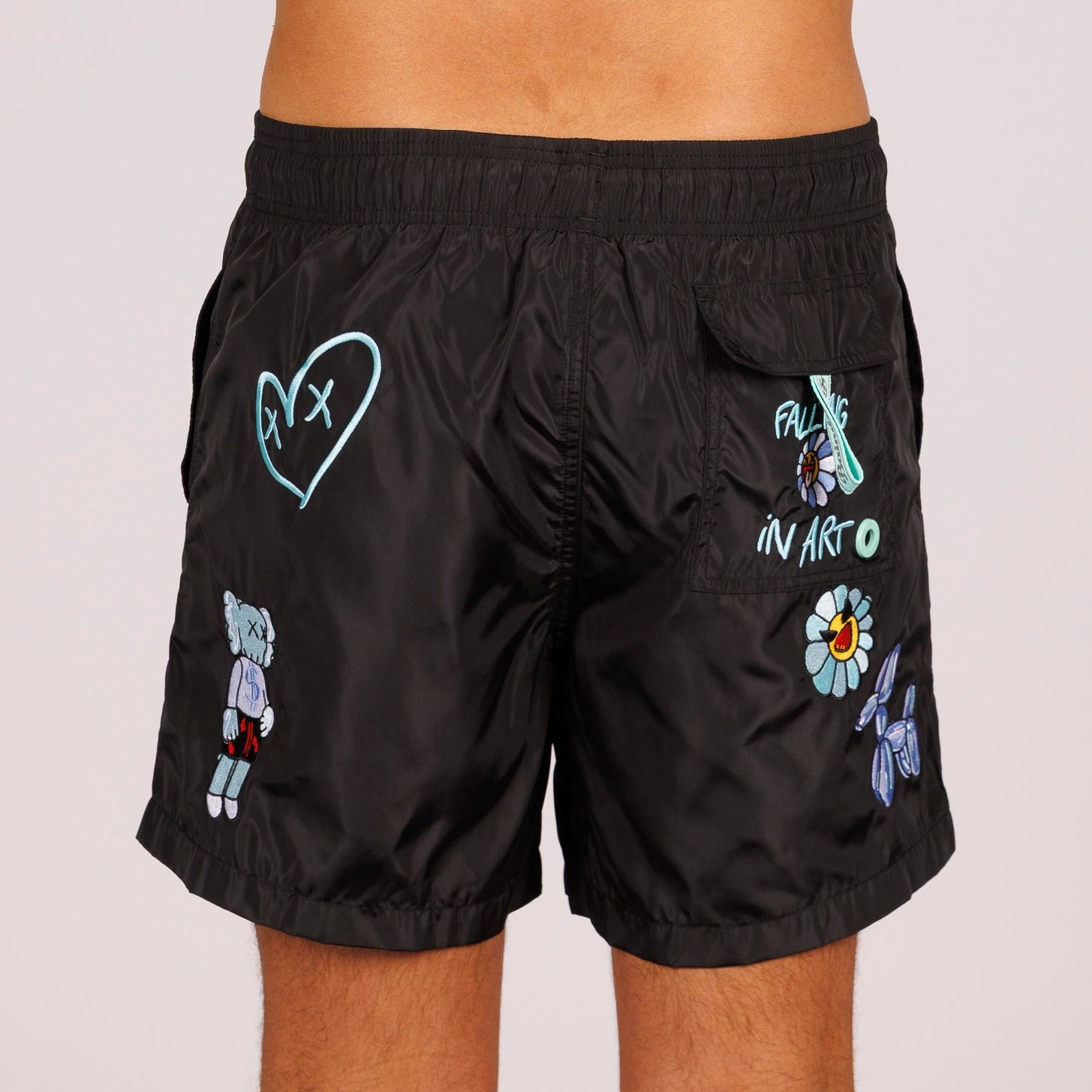 Black swim shorts back view with illustrated graphic