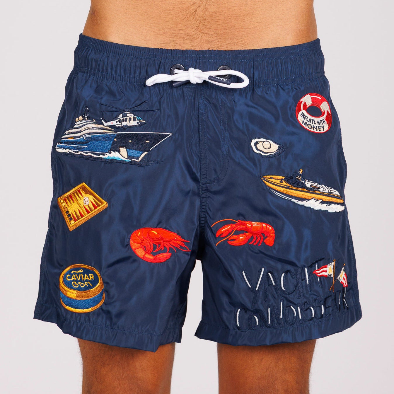 Navy blue swim shorts front view with illustrated graphic and “Yacht connoisseur” text